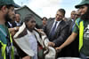 Deputy Minister Marius Fransman with Ebrahim Yacoob Vahed (far left) and Mahmood Ahmed Asvat (far right), help to hand out a blanket to a Madagascar lady, donated by Al-Imdaad Foundation based in South Africa. Ebrahim and Mahmood are from the Al-Imdaad Foundation, 13 March 2012.