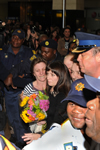 Debbie Calitz and her daughter, Carri-Anne, are surrounded by police officers at the International Arrivals Terminal of the O. R. Tambo International Airport in Johannesburg.