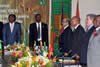 Benin President Thomas Boni Yayi of Benin, President Melese Zenawi of Ethiopia, President Jacob Zuma of South Africa and other delegation members rise for the AU Anthem.