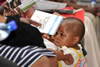 A small baby girl from the Polokwane community attends the first BRICS roadshow Polokwane, Limpopo, South Africa, 23 January 2013.