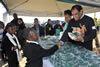 Deputy Minister Ebrahim Ebrahim hands out food and pencil cases to children at the Diepsloot Combined School during the DIRCO Nelson Mandela Day, Diepsloot, South Africa, 22 July 2013.