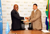 Deputy Minister Marius Fransman and UN Resident Representative, Dr. Agostinho Zacarias, exchange documents at the conclusion of the signing ceremony, Pretoria, South Africa, 26 February 2013.