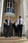 Deputy Minister Marius Fransman (far right) walks with Professor Cyril Karabus outside the South African Embassy in Abu Dhabi, United Arab Emirates, 3 March 2013.