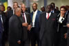 President Jacob Zuma walks towards the conference venue with President Tom Thabane of Lesotho (left on image) and President Robert Mugabe of Zimbabwe (right of image), Pretoria, South Africa, 15 September 2014.