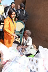 Minister Maite Nkoana-Mashabane meets an elderly lady who was a recipient of a bed, two bunk-beds and bedding from the Chinese Embassy and also some food stuff donated by DIRCO staff during the 67 minutes of Mandela Day, Winterveldt, Pretoria, South Africa, 17 July 2015.