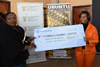 Minister Maite Nkoana-Mashabane hands over a cheque to a representative of the Nelson Mandela Trust during the 67 minutes of Mandela Day, Winterveldt, Pretoria, South Africa, 17 July 2015.