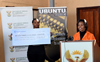 Minister Maite Nkoana-Mashabane hands over a cheque to a representative of the Nelson Mandela Trust during the 67 minutes of Mandela Day, Winterveldt, Pretoria, South Africa, 17 July 2015.